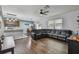 Spacious living room featuring a large sectional sofa and hardwood floors at 35744 Jenny Lynne Cir, Zephyrhills, FL 33541