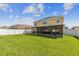 Large backyard with two story home and screened patio at 35744 Jenny Lynne Cir, Zephyrhills, FL 33541