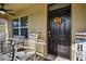 Inviting front porch with rocking chairs and fall decor at 35744 Jenny Lynne Cir, Zephyrhills, FL 33541