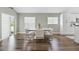Modern dining room with white table and chairs near sliding doors at 9733 Long Meadow Dr, Tampa, FL 33615