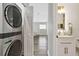 Convenient laundry room with stackable washer and dryer, plus a half-bathroom at 9733 Long Meadow Dr, Tampa, FL 33615