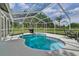 Relaxing kidney-shaped pool with screened enclosure at 9733 Long Meadow Dr, Tampa, FL 33615