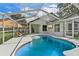 Inviting pool area with screened enclosure and patio furniture at 9733 Long Meadow Dr, Tampa, FL 33615