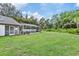 Spacious backyard with a screened pool and lush landscaping at 9733 Long Meadow Dr, Tampa, FL 33615