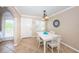 Bright dining room with white table and chairs at 19417 Gulf Blvd # E211, Indian Rocks Beach, FL 33785