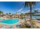 Community pool with lounge chairs and water view at 19417 Gulf Blvd # E211, Indian Rocks Beach, FL 33785