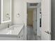 Modern bathroom with white vanity and a view into another room at 1701 Pinehurst Rd # 24H, Dunedin, FL 34698