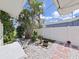 Tranquil backyard featuring a rock garden, tropical landscaping, and a privacy fence for outdoor enjoyment at 1385 Embassy Dr, Clearwater, FL 33764