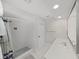 Bathroom with a walk-in shower, sleek vanity and storage at 1385 Embassy Dr, Clearwater, FL 33764