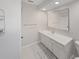 Clean bathroom featuring a vanity with sink, large mirror, and tiled shower at 1385 Embassy Dr, Clearwater, FL 33764