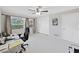 Bedroom features a large window, neutral walls, and closet storage at 1385 Embassy Dr, Clearwater, FL 33764