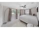 Well-lit bedroom with three windows, a ceiling fan, and neutral décor at 1385 Embassy Dr, Clearwater, FL 33764