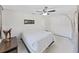 Bright bedroom with a ceiling fan, closet, and unique decor at 1385 Embassy Dr, Clearwater, FL 33764