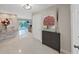 Inviting foyer with sleek flooring, modern lighting, and view of the pool through the living room at 1385 Embassy Dr, Clearwater, FL 33764