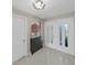 Bright foyer featuring stylish light fixture, decorative artwork, and an elegant double-door entryway at 1385 Embassy Dr, Clearwater, FL 33764