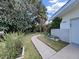 Landscaped front yard featuring a stone walkway, green grass, and established plants leading to the home's entrance at 1385 Embassy Dr, Clearwater, FL 33764