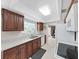 Bright kitchen features wood cabinets, speckled countertops, and a window for natural light at 1385 Embassy Dr, Clearwater, FL 33764