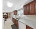 Bright kitchen featuring wood cabinets, plenty of counter space, and open dining area at 1385 Embassy Dr, Clearwater, FL 33764