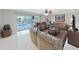 Spacious living room with comfortable seating, a ceiling fan, and a view of the pool area through sliding glass doors at 1385 Embassy Dr, Clearwater, FL 33764