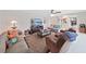 Inviting living room with stylish furnishings, a large TV, and a seamless transition to other living spaces at 1385 Embassy Dr, Clearwater, FL 33764