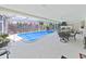 Enclosed pool area featuring a kitchen and outdoor dining space at 1385 Embassy Dr, Clearwater, FL 33764