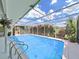Inviting screened-in pool with clear blue water and a lush landscape view, perfect for relaxation and outdoor enjoyment at 1385 Embassy Dr, Clearwater, FL 33764