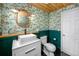 Stylish bathroom with an accent wall, vessel sink on white vanity, and unique wallpaper at 6619 Livingston N Ave, St Petersburg, FL 33702