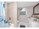 Charming bathroom featuring a shower-tub combo, a toilet, and a vanity sink with ample lighting at 6619 Livingston N Ave, St Petersburg, FL 33702