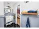 Bathroom featuring updated vanity, black tile floor, and doorway to a bedroom with hardwood floors at 6619 Livingston N Ave, St Petersburg, FL 33702