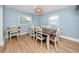 Traditional dining room with wood floors, light blue walls, and a wooden table at 6619 Livingston N Ave, St Petersburg, FL 33702