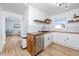 Modern kitchen with butcher block counters, white cabinets, stainless steel appliances, and an adjacent dining area at 6619 Livingston N Ave, St Petersburg, FL 33702