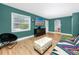 Cozy living room with a large window, laminate flooring, accent furniture, and an arched doorway at 6619 Livingston N Ave, St Petersburg, FL 33702