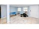 Inviting living room area with tile floors, a TV, a comfortable chair, and staircase access at 6619 Livingston N Ave, St Petersburg, FL 33702