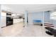 Open-concept living area with a kitchen, staircase and comfortable seating arrangement at 6619 Livingston N Ave, St Petersburg, FL 33702