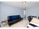 Functional room with a futon, desk, and chair, ideal for office or relaxing space at 6619 Livingston N Ave, St Petersburg, FL 33702