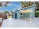 View of the home's patio with awning, surrounded by wood fence and trees at 6619 Livingston N Ave, St Petersburg, FL 33702
