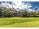 Property is nestled amongst trees with a view of the golf course at 9 Pelican Pl, Belleair, FL 33756