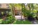 Backyard view with patio seating, a lush garden, and mature trees at 9 Pelican Pl, Belleair, FL 33756