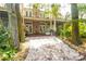 The home offers a spacious backyard with lush landscaping, creating a serene outdoor oasis at 9 Pelican Pl, Belleair, FL 33756