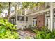 Charming patio with decorative furniture and lush garden, perfect for outdoor relaxation at 9 Pelican Pl, Belleair, FL 33756