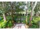 Landscaped backyard with lush greenery and trees at 9 Pelican Pl, Belleair, FL 33756