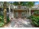 The property has a private backyard with white pebble landscaping and beautiful brick paver accents at 9 Pelican Pl, Belleair, FL 33756