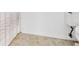 Close-up bathroom shows a shower with curtain, ceramic tile flooring, and a toilet at 9 Pelican Pl, Belleair, FL 33756
