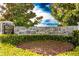 Pelican Private Club entrance sign with stone wall and landscaping at 9 Pelican Pl, Belleair, FL 33756