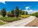 Landscaped community entrance with lush greenery and paved walkway at 9 Pelican Pl, Belleair, FL 33756