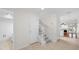 Entrance foyer featuring tile flooring, staircase, and access to main living areas at 9 Pelican Pl, Belleair, FL 33756
