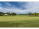 Scenic view of the golf course with lush green grass and blue skies at 9 Pelican Pl, Belleair, FL 33756
