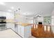 Kitchen featuring modern appliances, and a breakfast bar, adjacent to the living area at 9 Pelican Pl, Belleair, FL 33756