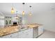 Kitchen island with sink, dishwasher, and gorgeous granite countertops at 9 Pelican Pl, Belleair, FL 33756