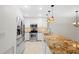 Modern kitchen with stainless steel appliances, granite counters, and ample cabinet space at 9 Pelican Pl, Belleair, FL 33756
